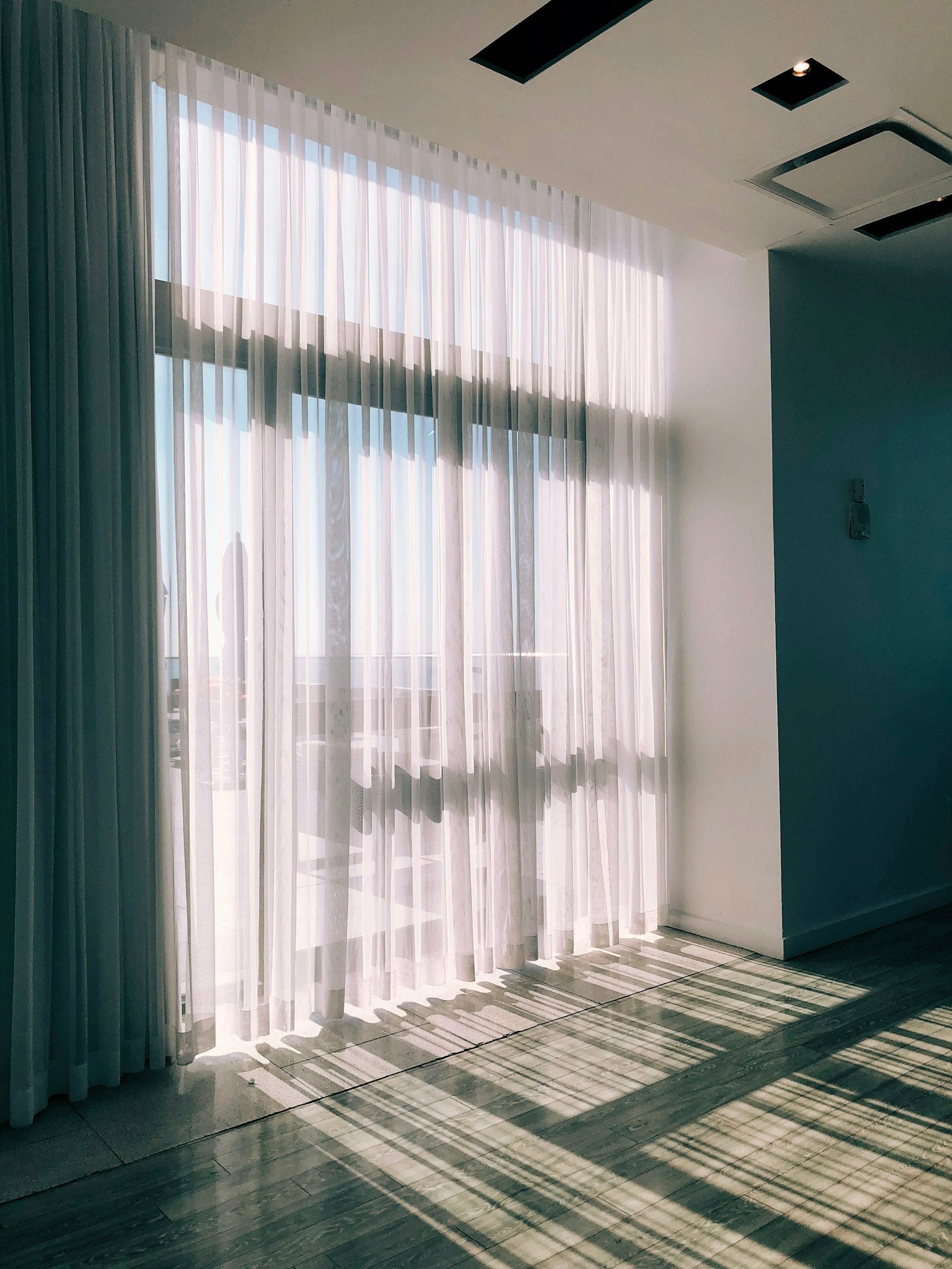 Sheer white voile curtains by a window