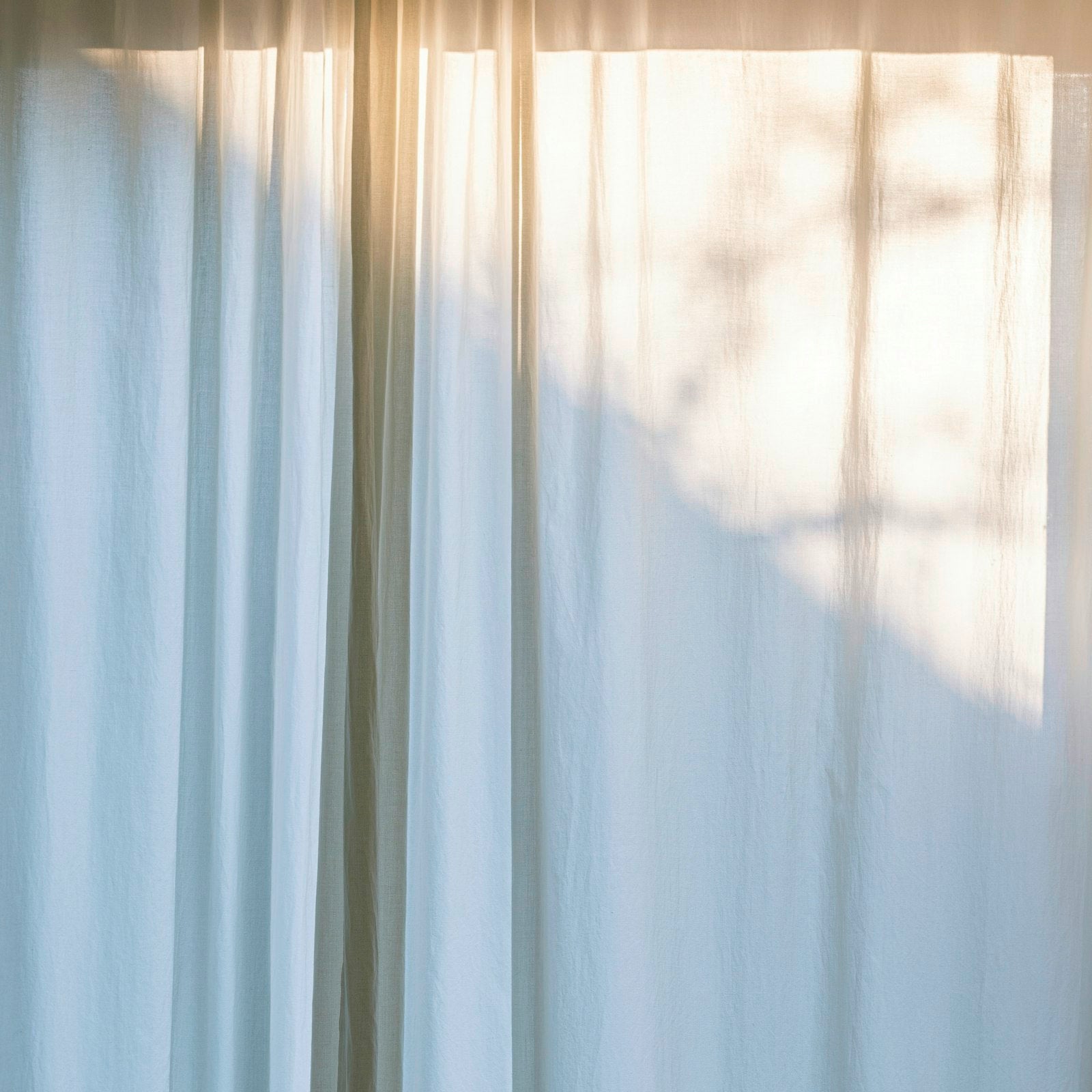 Freshly hung clean curtains in a bright room