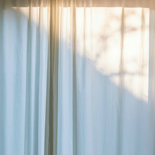 Freshly hung clean curtains in a bright room